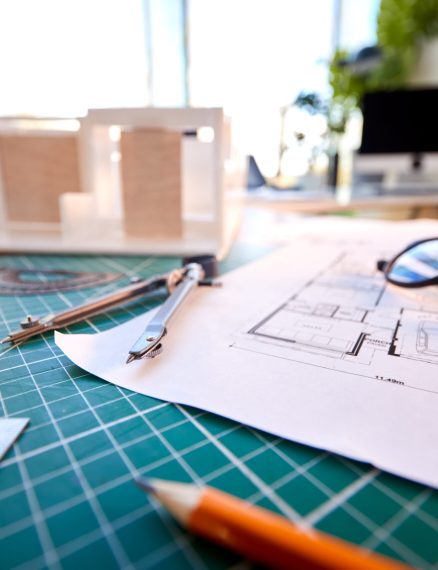 Desk In Architects Office With Plans Drawing Instruments And Model Desk In Architects Office With Plans Drawing Instruments And Model